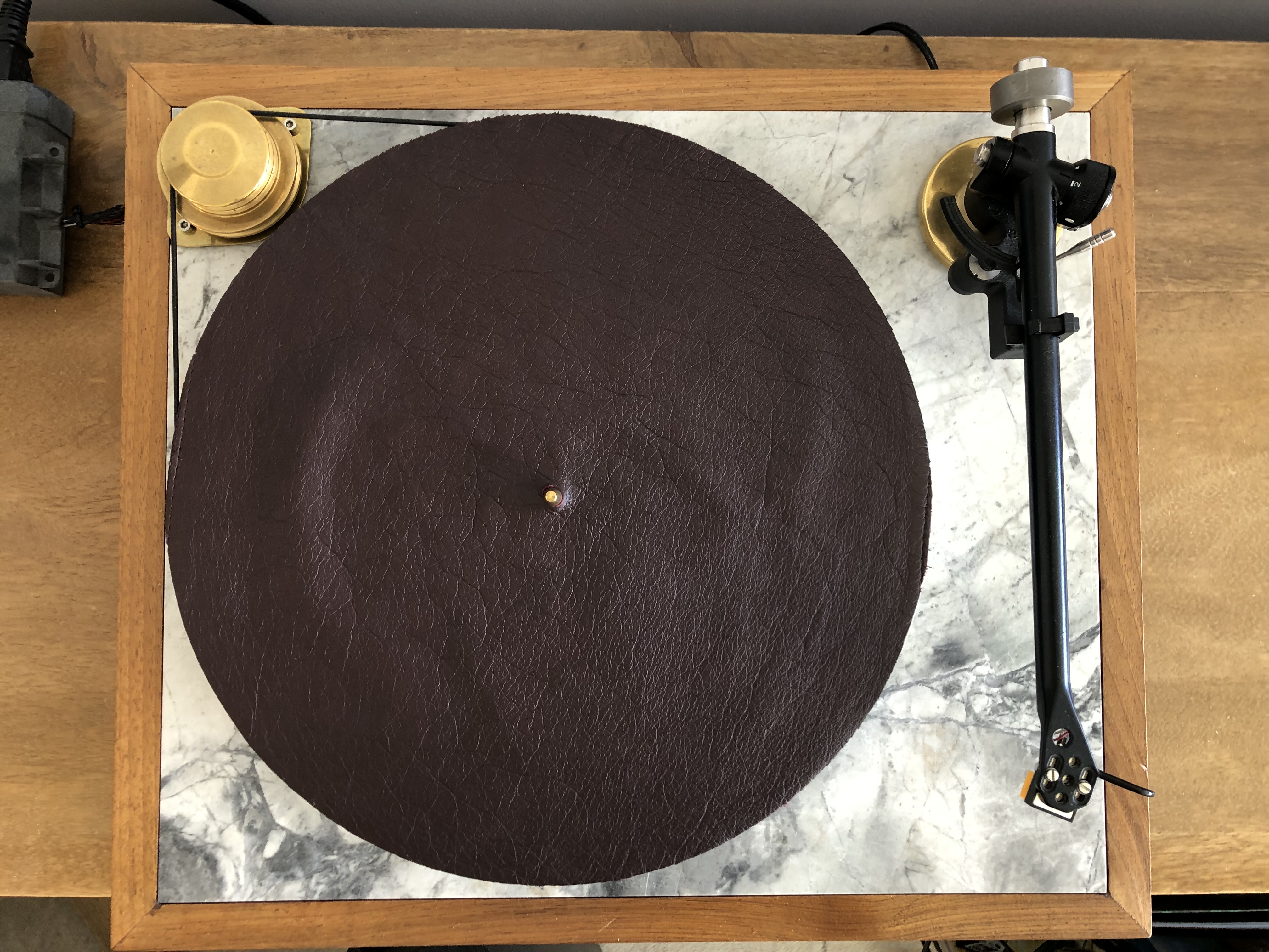 Dark leather platter mat, top-down view on marble